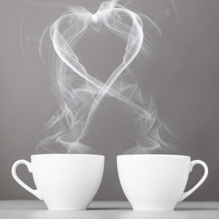 Two cups of tea, their steam merging together in a heart shape