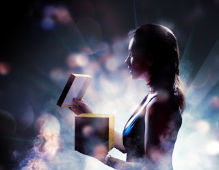 Woman opening box of light and sparkles