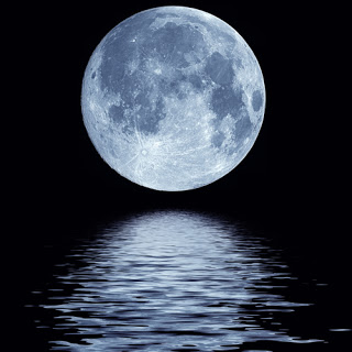 Full moon rising over the water