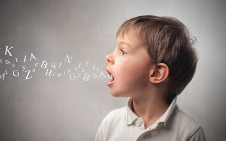 Small boy with letters coming out his throat