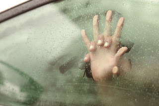 Couple's hands against steamy car window