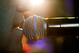 Male face up close to microphone