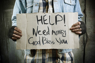 Man with sign: 'Help! Need money, God bless you'