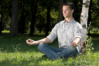 Man in park meditating