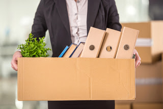 Person carrying box of work possessions