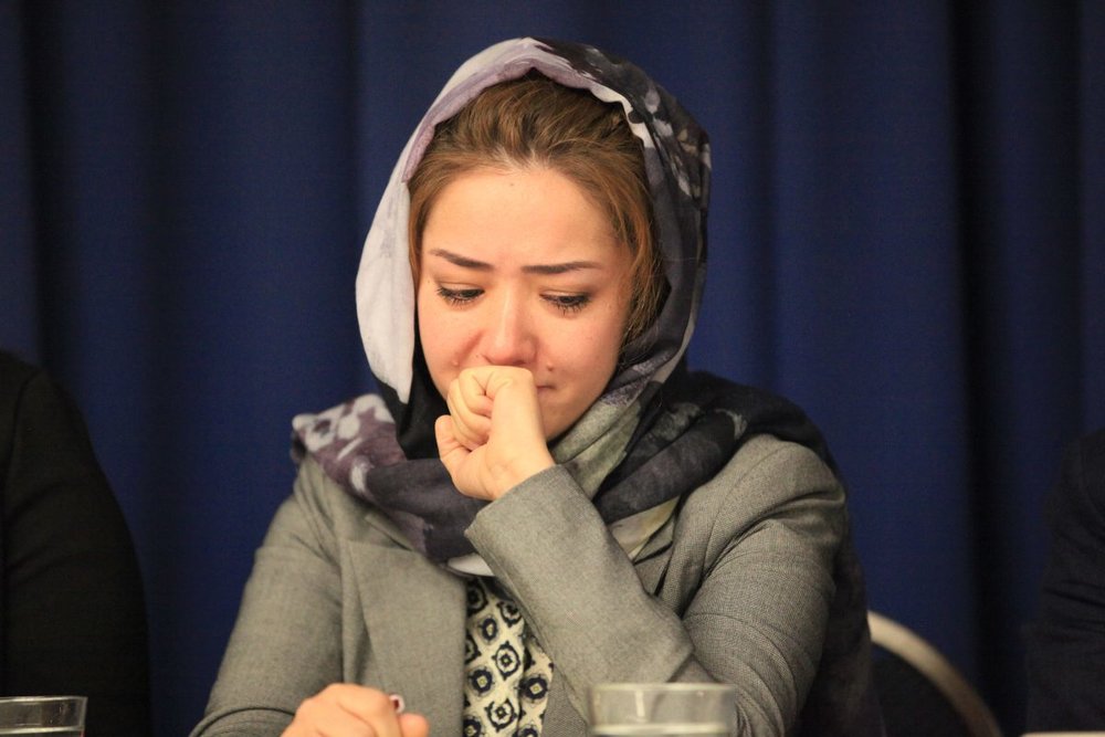 Mihrigul Tursun weeps as she relates her experiences in the detainment camps in Xinjiang, China, at the National Press Club in Washington on Nov. 26, 2018. (Jennifer Zeng/The Epoch Times)