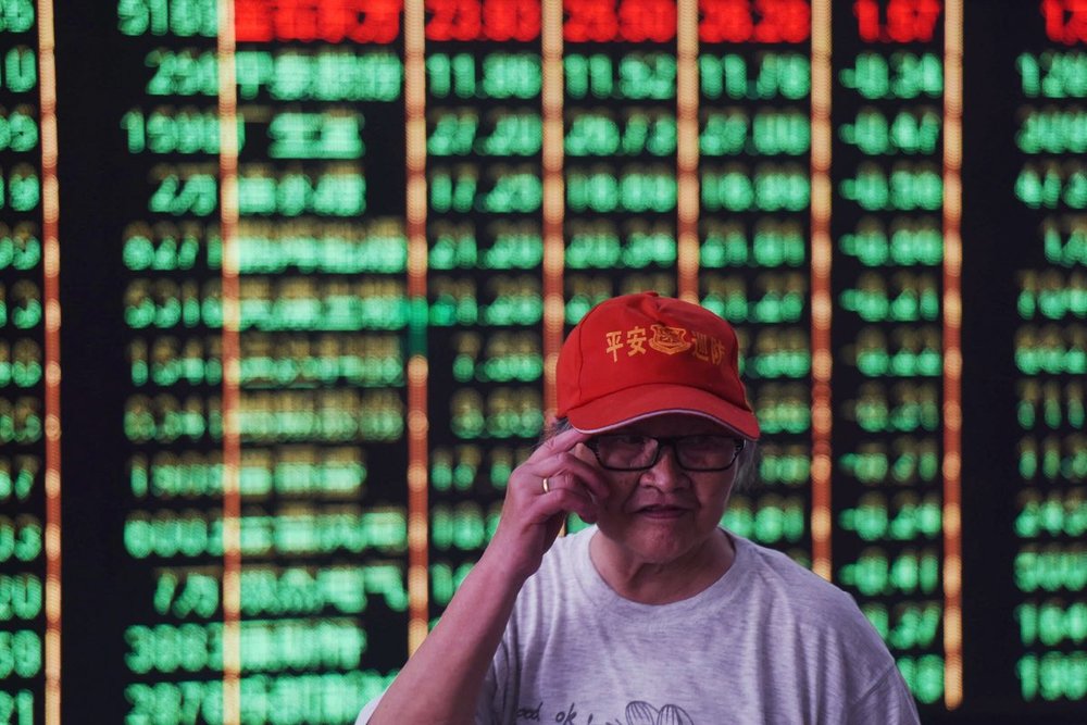 An investor stands in front of a screen displaying stock market figures at a securities company in Hangzhou in China’s Zhejiang Province on June 19, 2018. Shanghai and Hong Kong stocks plunged on June 19 on investors’ fears that the US and China could be heading for a full-blown trade war following tit-for-tat tariff threats. (-/AFP/Getty Images)