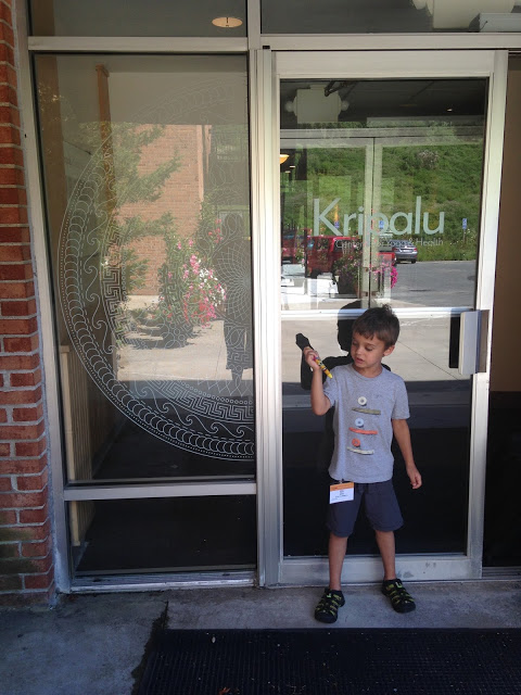 5 year old Eli standing in front of the Kripalu door