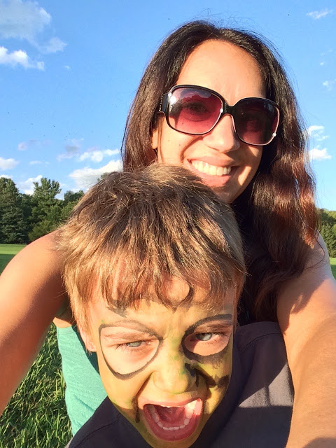 Selfie of Marisa wearing sunglasses with her son Eli in facepaint