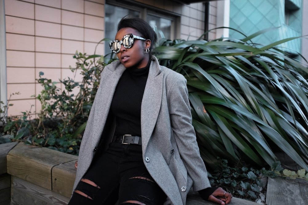 Fashion blogger wearing Go Go Go LeSpecs sunglasses long grey asos coat ripped black jeans 