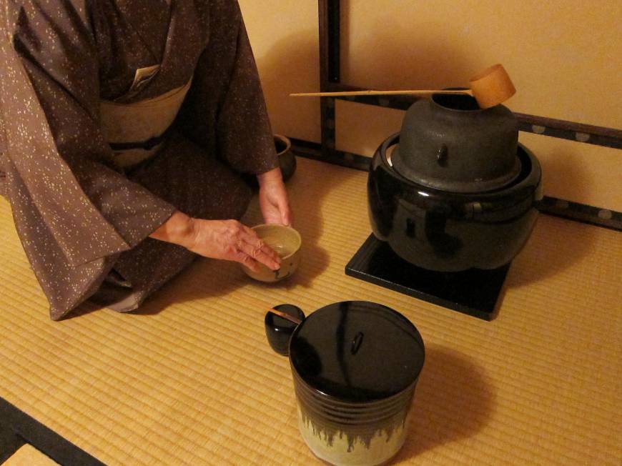 This photo provided by the Urasenke Chanoyu Center shows host Masako Soyu Miyahara purifying a tea whisk in front of guests at the institute in New York.jpg