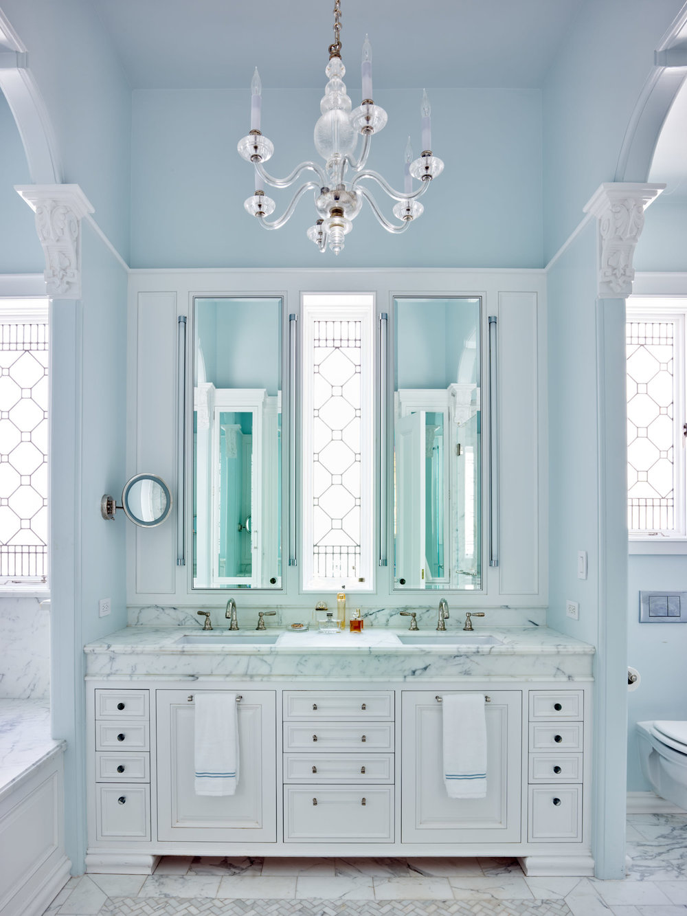The restfully symmetrical new master bath featuring stained glass windows. Renovated historical house in San Francisco. Stained glass windows by Victoria Balva