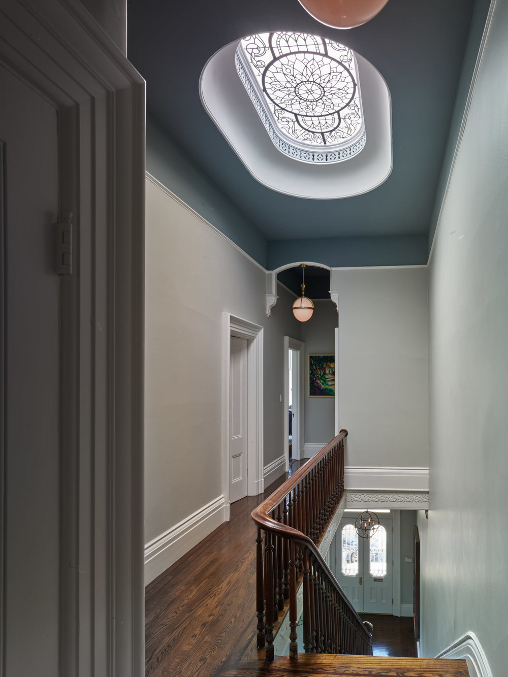 Stained leaded glass oval skylight with clear textured and hand bevelled glass for a restored historical house in San Francisco (Pacific Heights) brings natural light and elegance to the upper level hall
