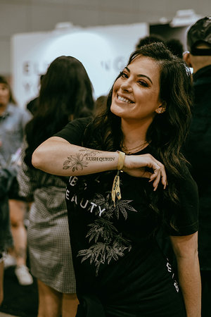 Owner & Founder of Kush Queen, Olivia Alexander, shows off tattoo on forearm reading "Kush Queen."