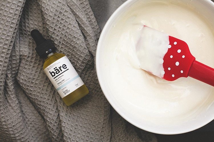 500mg Bare Tincture by Kush Queen sits next to bowl of melted white chocolate with red & white polka dot spatula.