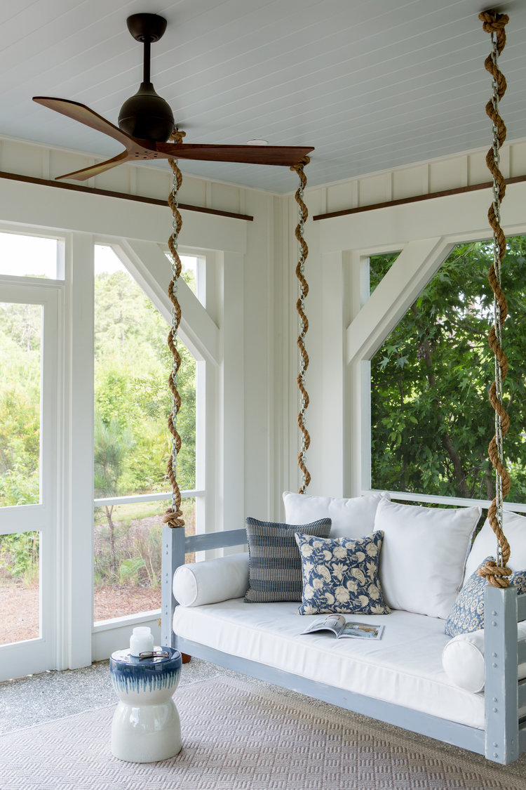 Screen porch with swing bed. Design by Lisa Furey. Board and batten siding. Coastal Cottage Interior Design Inspiration.