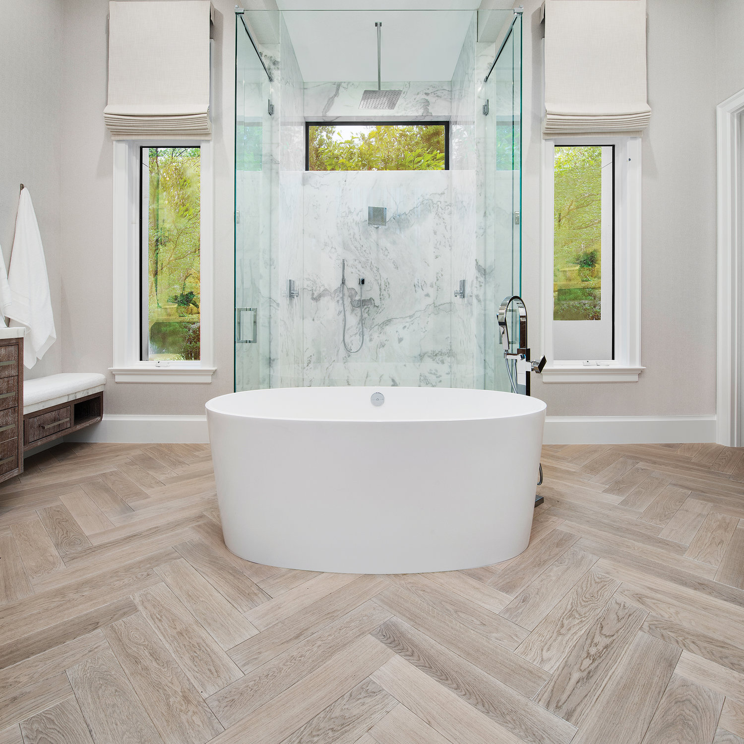 Here, herringbone has been used to create a solid and artistic foundation for this spa-like space. The different angles in this flooring pattern means the tones and colors will change slightly creating movement in the room.