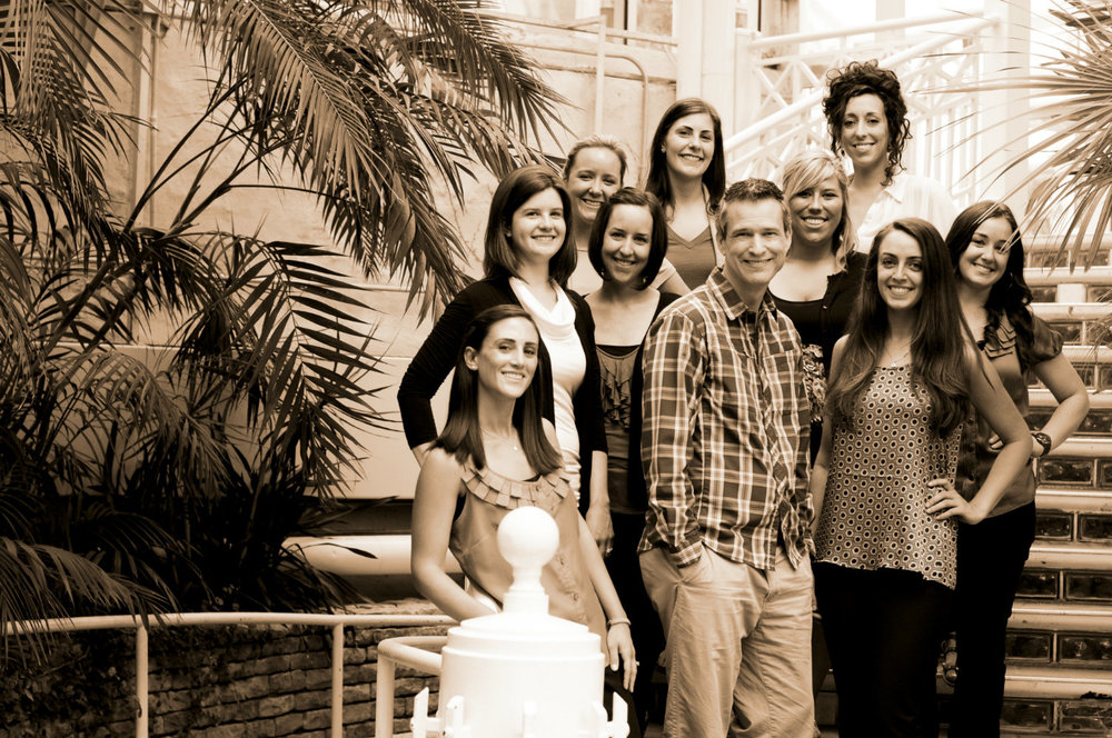 Palm House steps, officiant Damian King, stands with the wedding pros of the Conservatory in Columbus