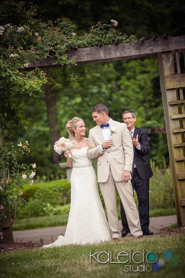 Bride & groom exit at Whetstone Park Columbus Ohio with wedding officiant in background