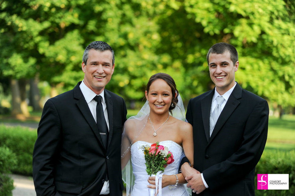 Columbus, Ohio, Jessica and Daniel stand with their wedding officiant, Damian, at Franklin Park Conservatory