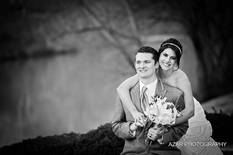 Azar Photography after wedding ceremony over - bride and groom hold bouquet in gentle pose.
