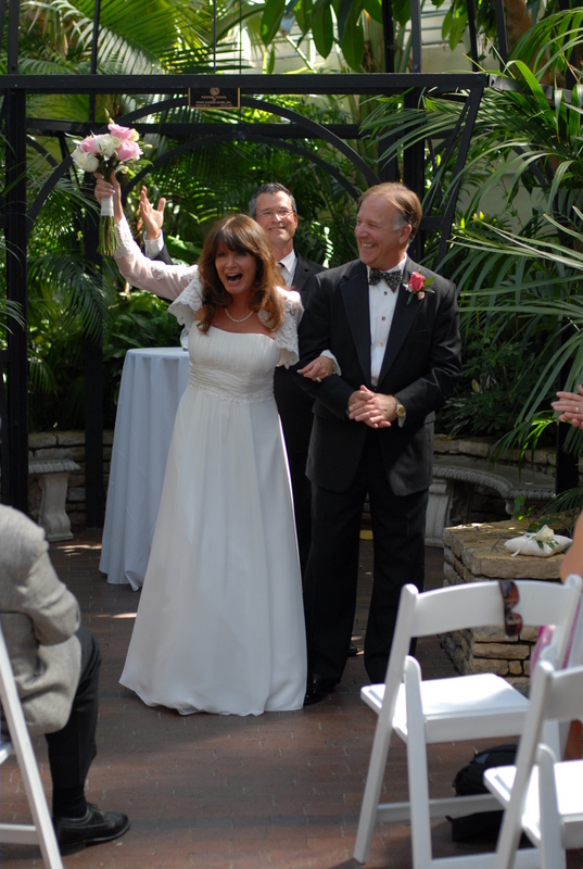 Wedding officiant Damian King pronounces Pam and Rick husband and wife at Franklin Park Conservatory in Columbus Ohio