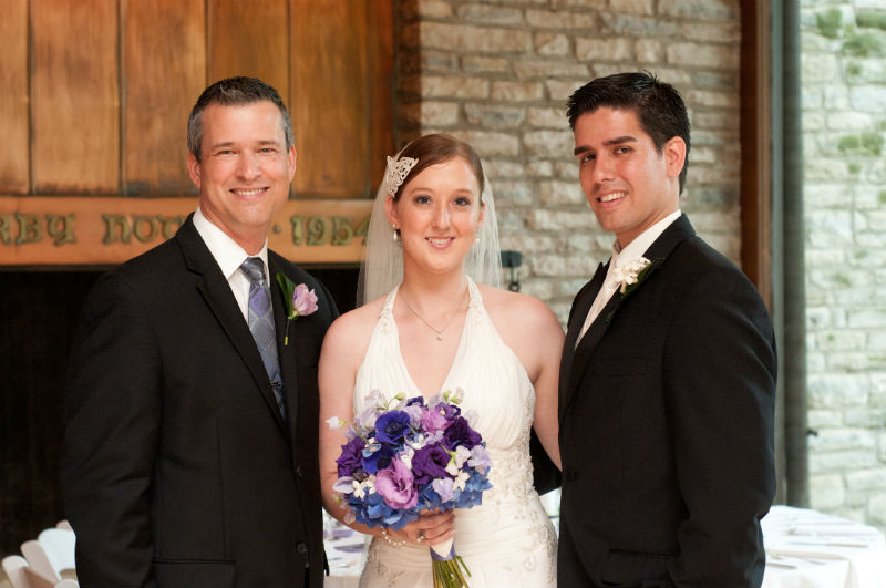 Jenny and Diego pose with wedding officiant, Damian King at Darby House in Columbus, Ohio