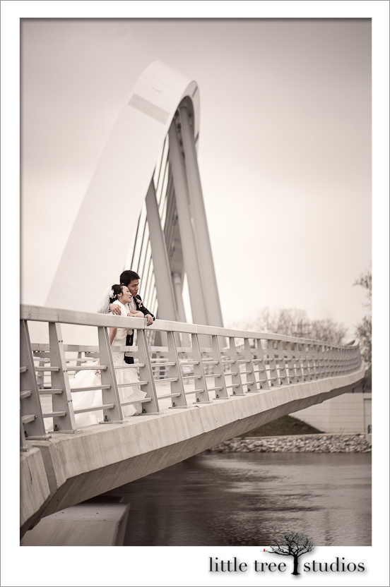 Bride, Joanna, and groom, Aaron, enjoy looking toward the future above the river in Columbus Ohio