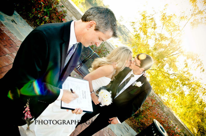 Wedding officiant,Damian King, signs marriage license in Columbus Ohio for Genevieve and Max