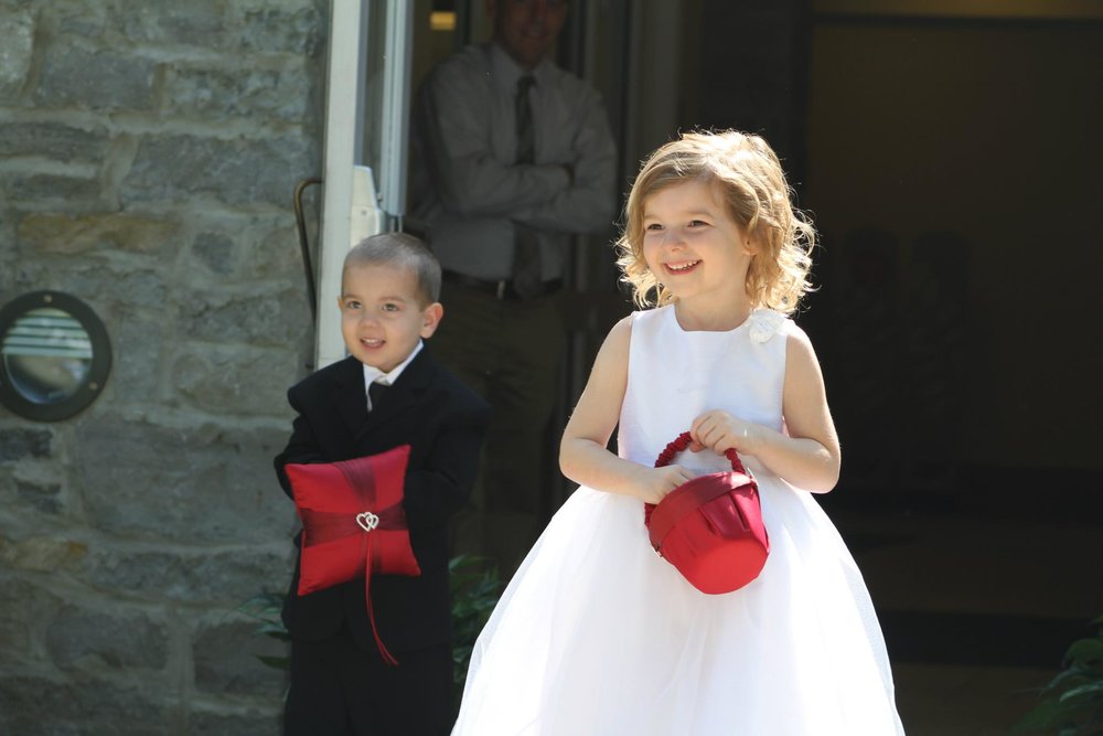 Ring bearer and Flower girl approach in Columbus Ohio as wedding officiant Damian King prepares to deliver ceremony