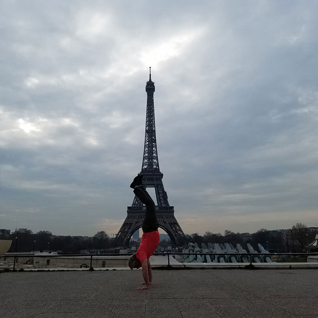 tom handstand in front of eiffle tower
