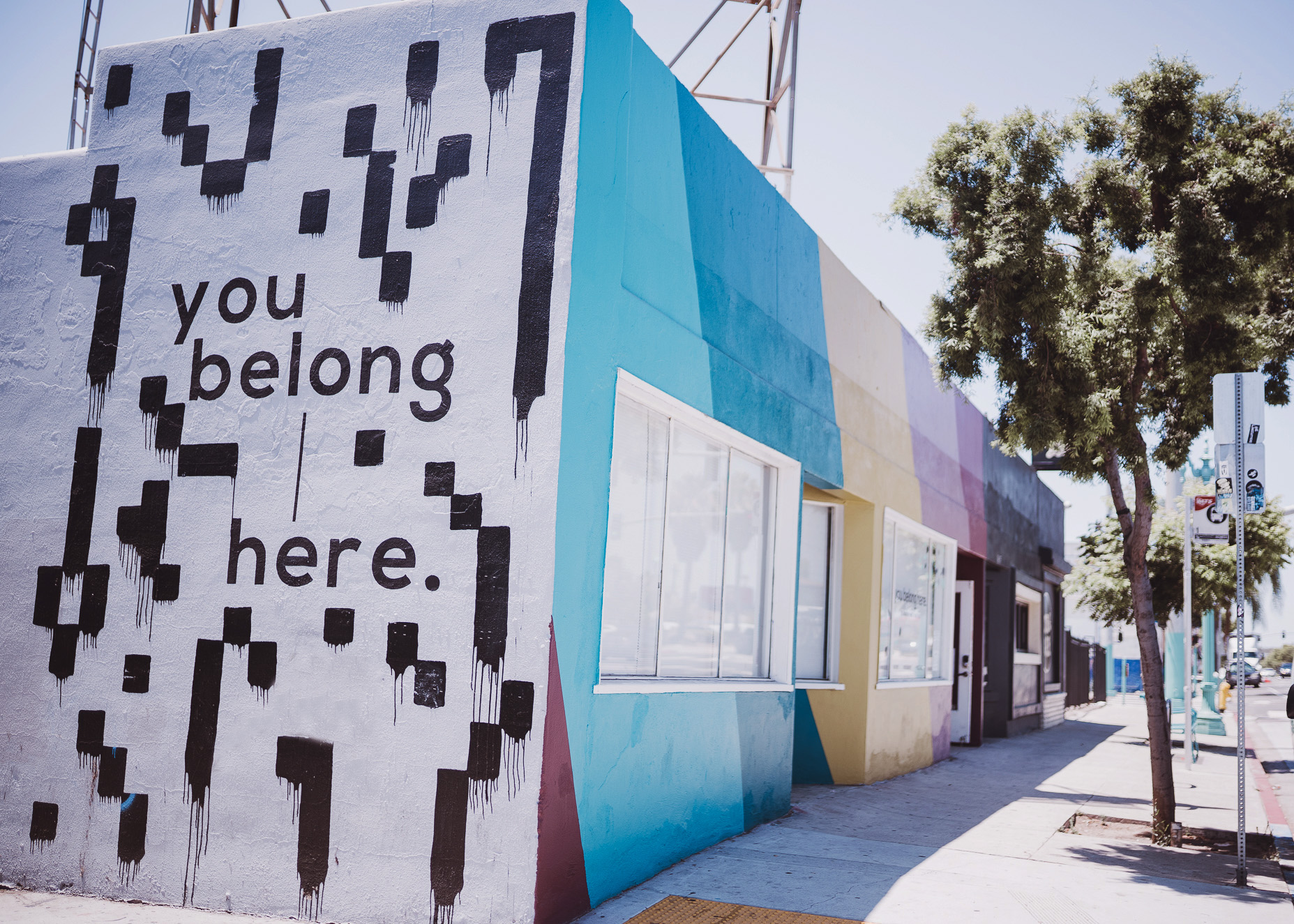 You Belong Here Incubator space for creatives and business support storefront and side, painted with colorful murals