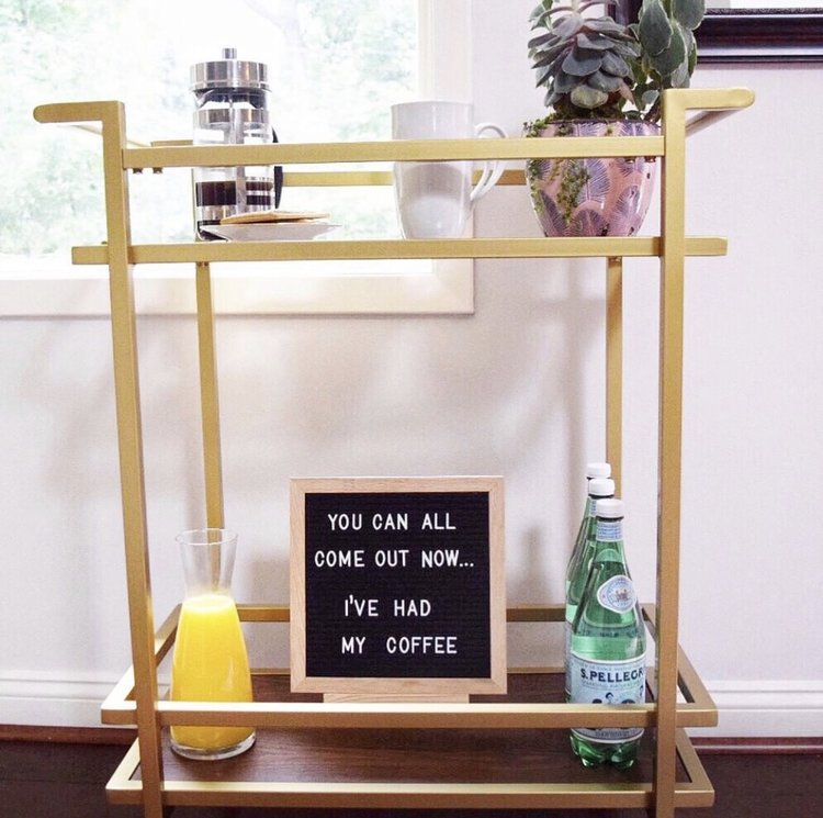 coffee bar cart with letter board, coffee, and orange juice