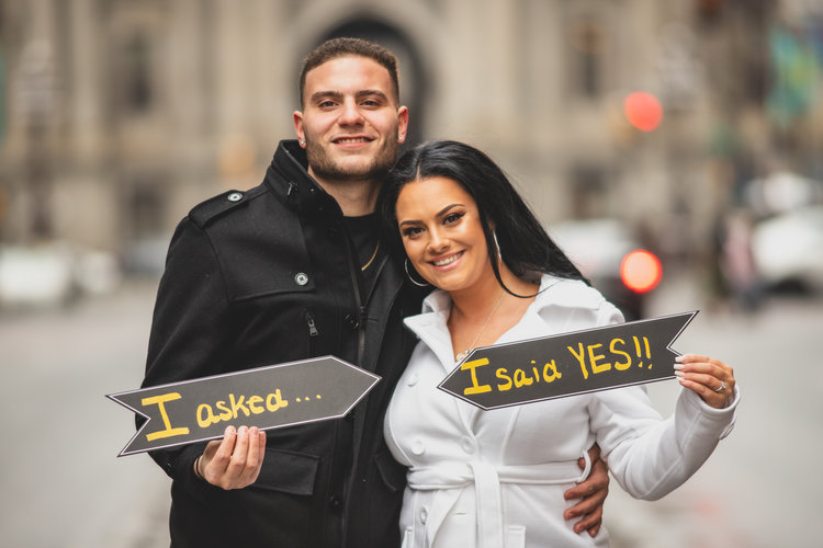 Engaged Couple Holding Diy Signs.