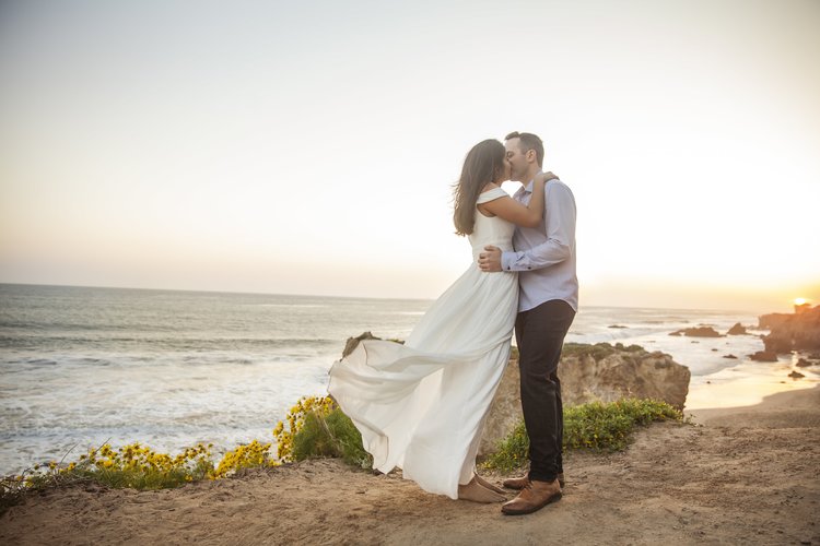 Unforgettable Save The Date Ideas - Engagement Photography Of A Couple Kissing On The Beach.