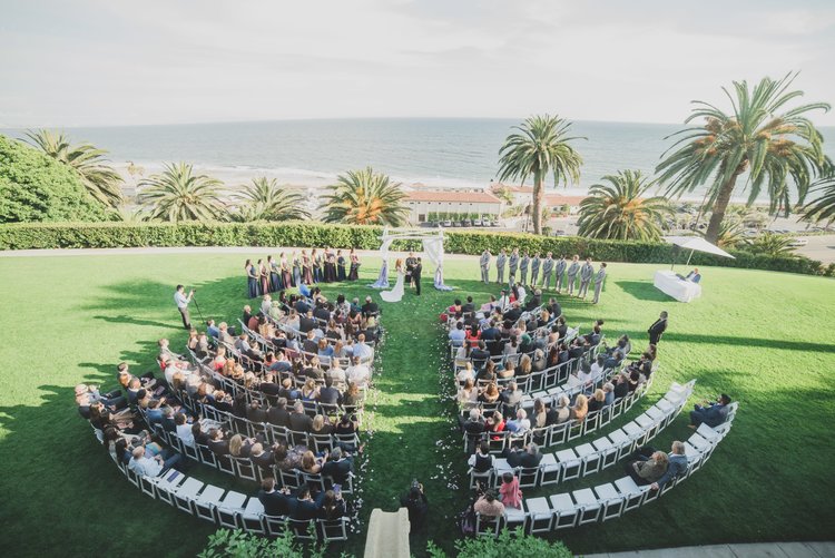 Ways To Keep Guests Cool At Your Warm-Weather Wedding - Aerial Shot Of A Beachfront Wedding Ceremony.