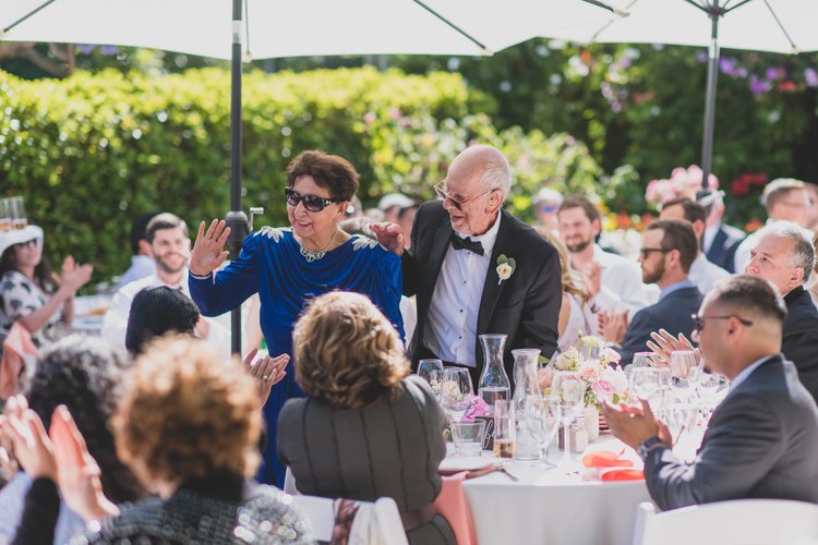 Last Minute Checklist: Things To Know Before Your Outdoor Wedding - An Older Couple Greet Guests As They Arrive At The Wedding Reception.