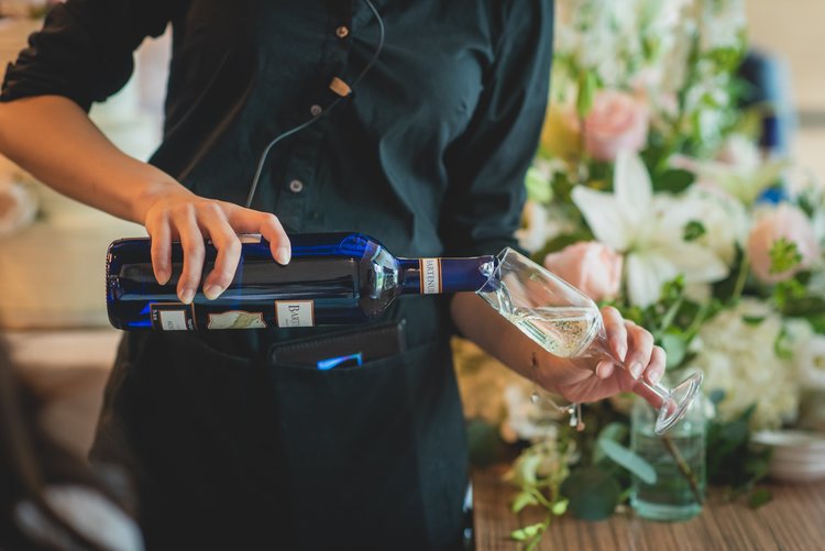 A Bartender Pouring A Glass Of Wine.