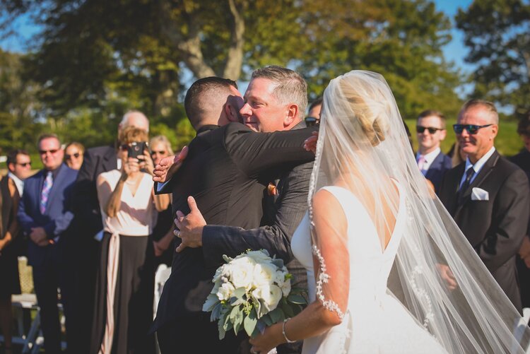 The Groom Hugging The Father Of The Bride After The Aisle Walk