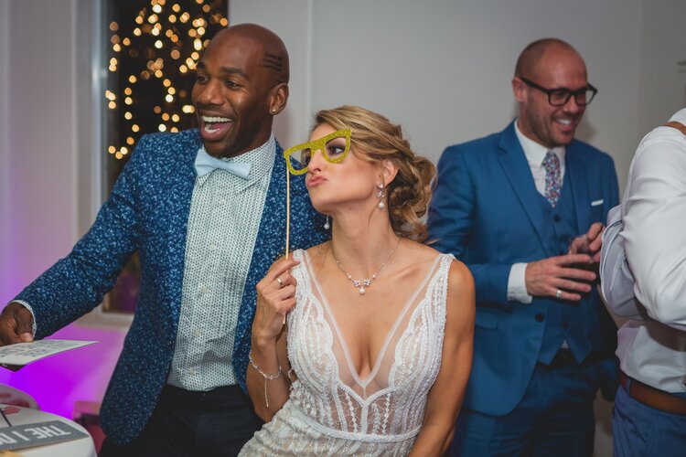 Bride With Gold Glasses As A Photo Booth Prop.