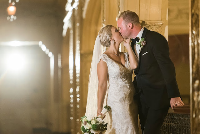 blonde bride and groom kiss in yellow room at embassy theater
