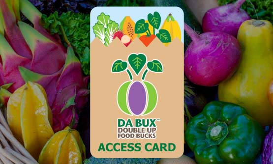 An image of a DA BUX Access Card superimposed over a colorful background of Hawaii grown fruits and vegetables.