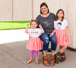 mother and two young daughters model shirts from the UGauGrrl line