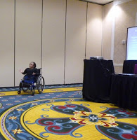 Vilissa in wheelchair, giving presentation