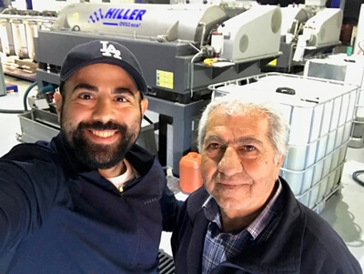 Hasan and his uncle at the mill, feeling relieved after successfully getting the olives there in the nick of time.