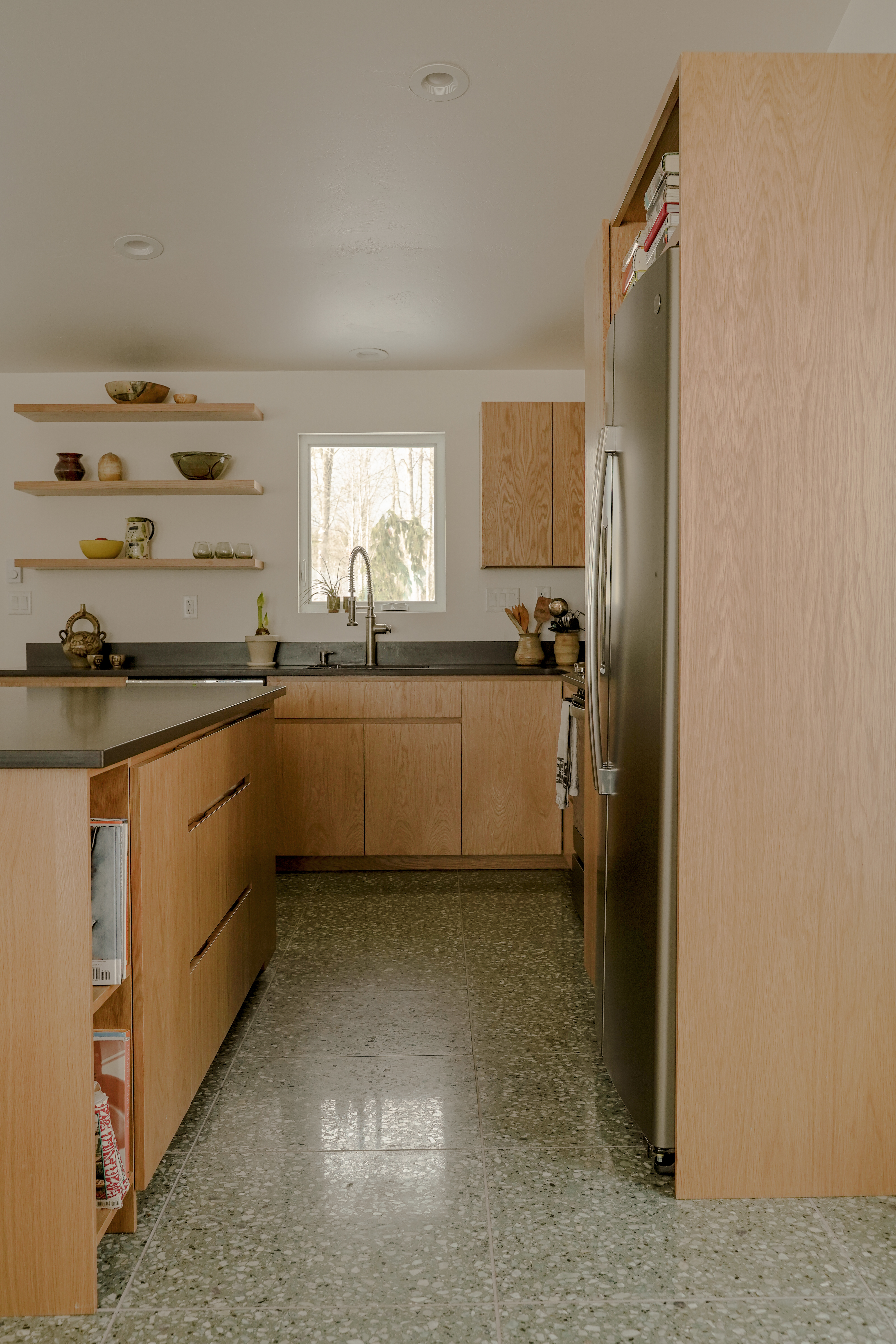 Kitchen renovation in Sturgeon Bay, Wisconsin, designed by Social Studies Projects. New terrazzo flooring and quarter-sawn white oak doors and drawers.