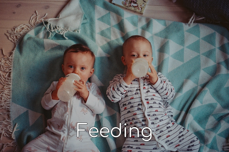 two babies drinking from bottles with the word feeding at the bottom of the image