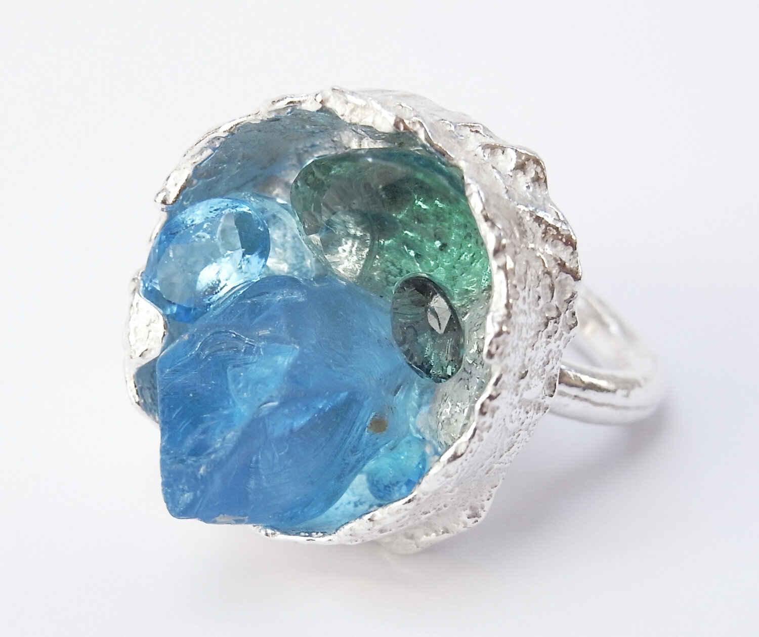 boxcast ring with gemstones in blue hues — Kelvin J Birk
