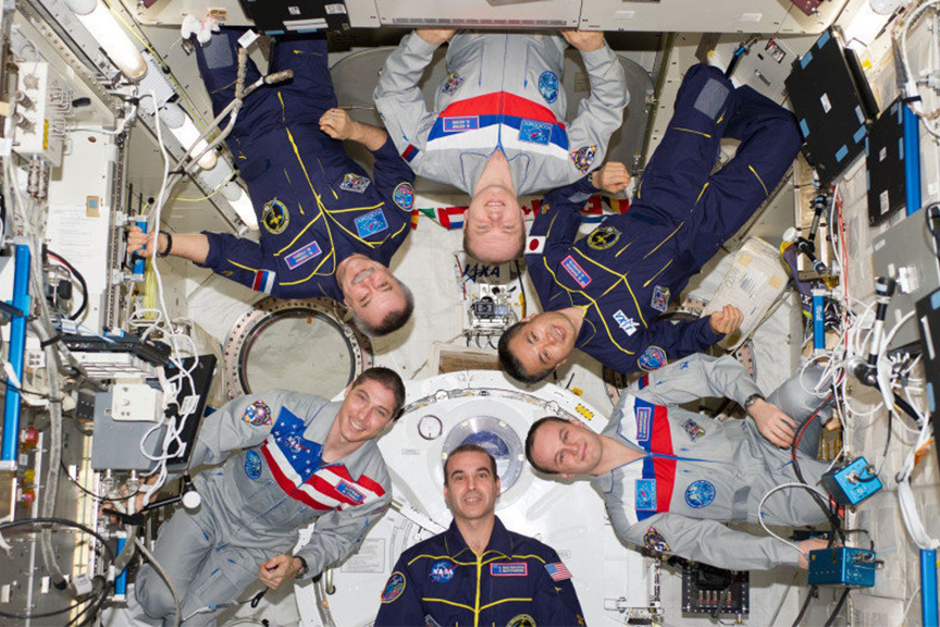 group photo from the ISS with people from different countries