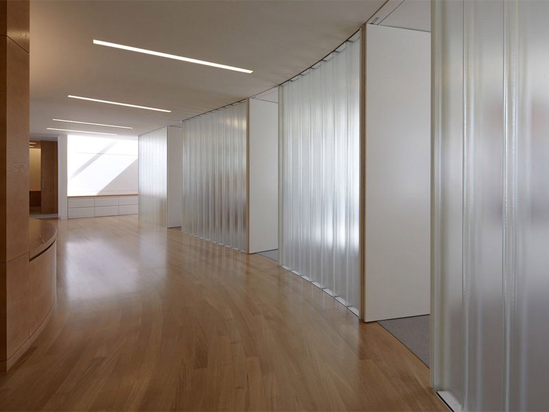 hallway with frosted glass office spaces